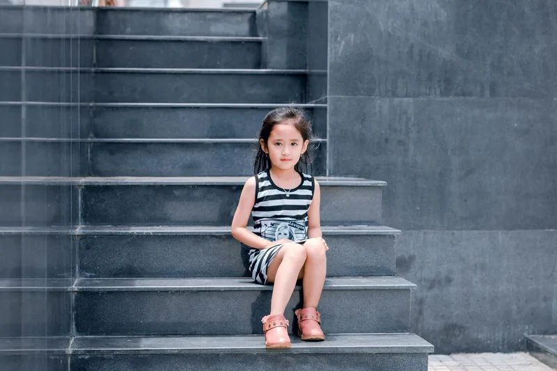 Child sitting on stone steps
