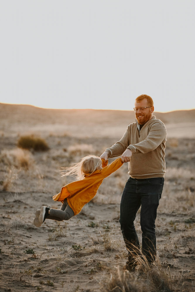 child and father playing