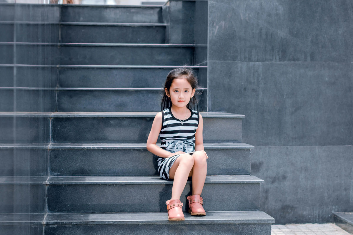 Child sitting on stone steps