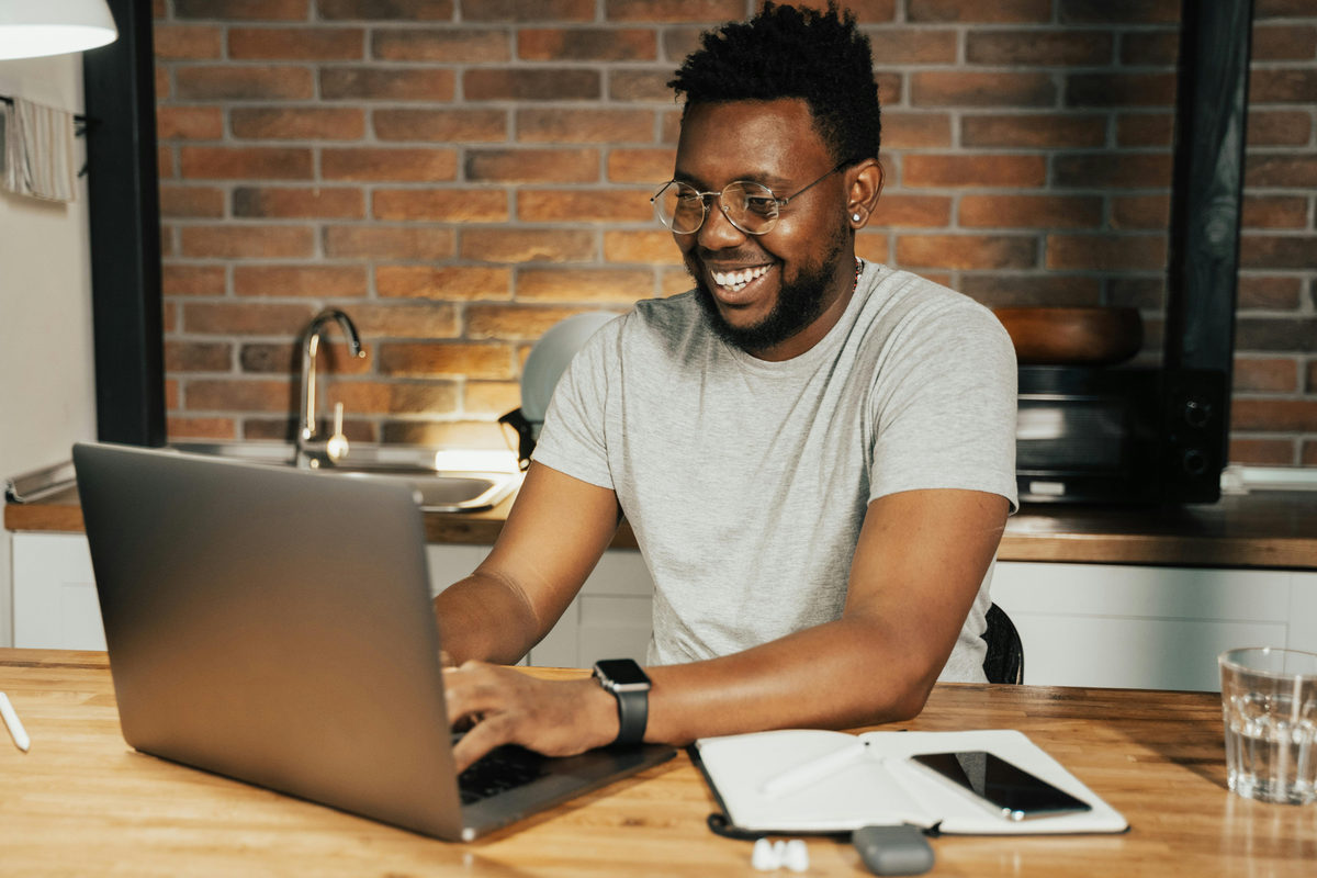 A person using a laptop at a table.