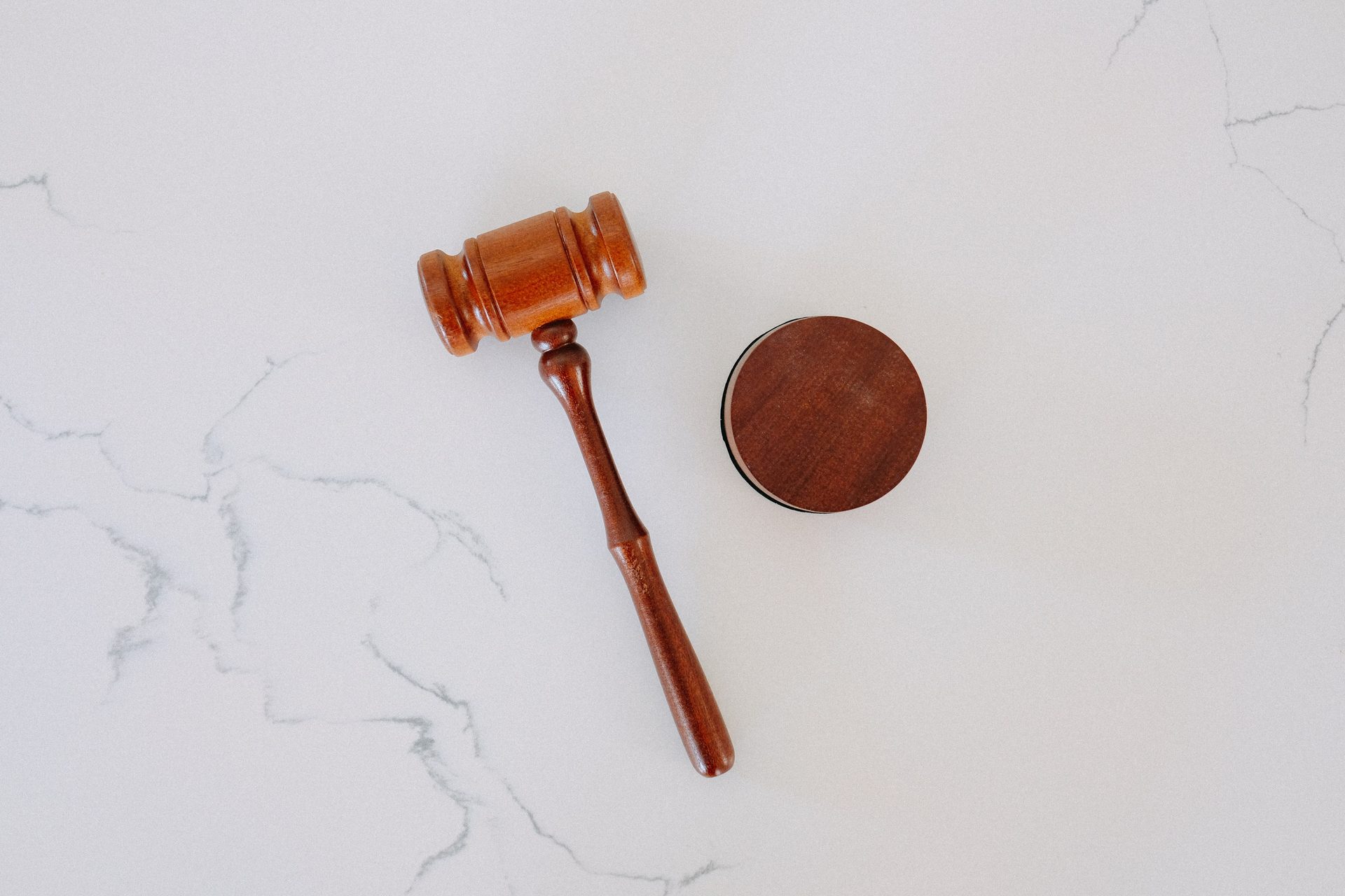 Wooden gavel and sound block on white marble